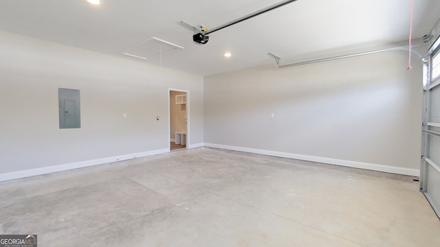 1013 Syrup Mill Creek Ln, Cairo, GA 39828 - garage featuring recessed lighting, electric panel, a garage door opener, and baseboards
