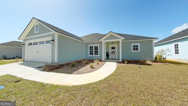 1013 Syrup Mill Creek Ln, Cairo, GA 39828 - view of front facade featuring a front yard, an attached garage, board and batten siding, and driveway