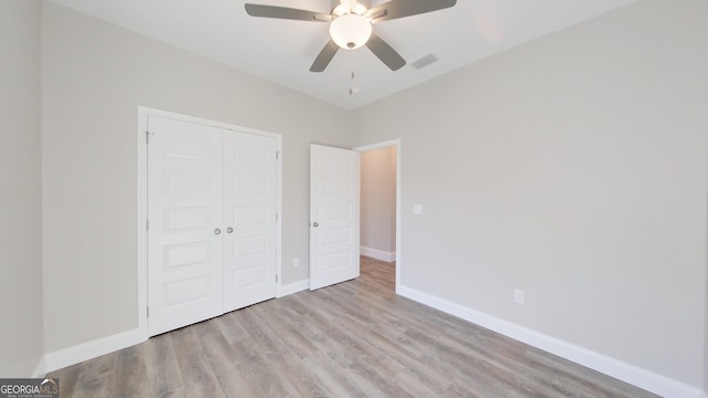 1013 Syrup Mill Creek Ln, Cairo, GA 39828 - unfurnished bedroom with a closet, baseboards, visible vents, and wood finished floors