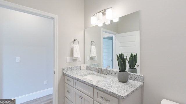1013 Syrup Mill Creek Ln, Cairo, GA 39828 - half bath with toilet, vanity, baseboards, and wood finished floors