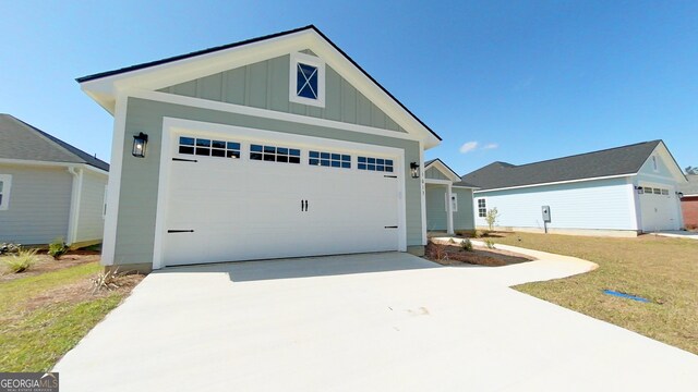 1013 Syrup Mill Creek Ln, Cairo, GA 39828 - view of front of house with an outbuilding, board and batten siding, and a garage