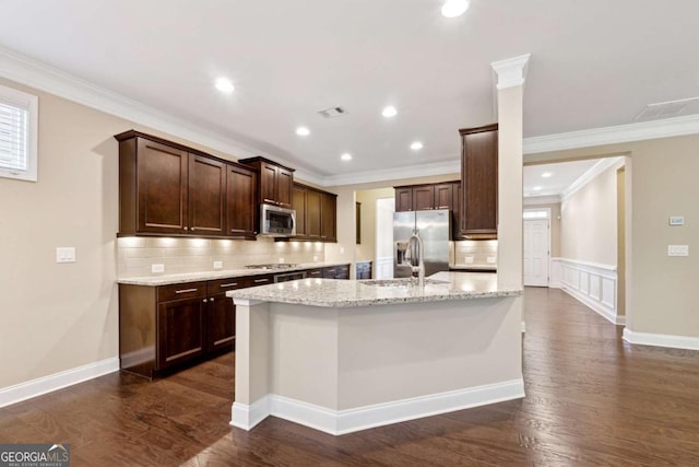 kitchen featuring dark wood-type flooring, stainless steel appliances, crown molding, and light stone countertops