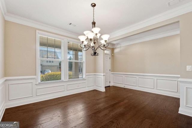 unfurnished dining area with a chandelier, ornamental molding, and dark hardwood / wood-style floors