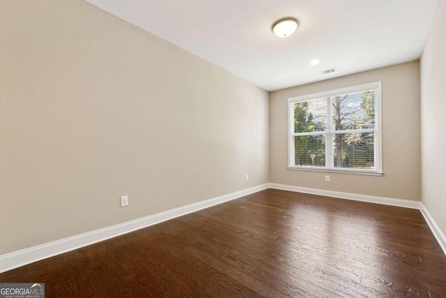 empty room featuring dark wood-type flooring