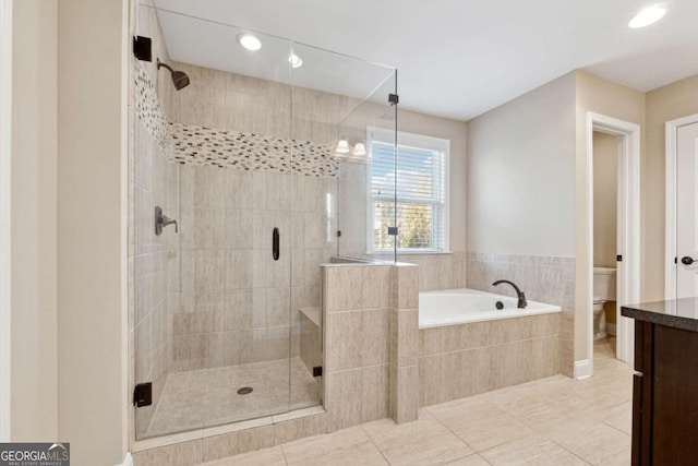 bathroom featuring toilet, independent shower and bath, and tile patterned floors