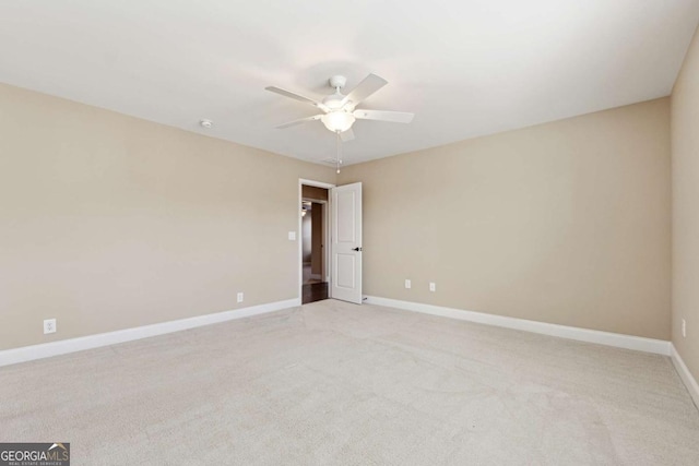 unfurnished room featuring ceiling fan and light carpet