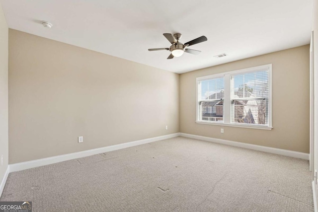 carpeted spare room with ceiling fan