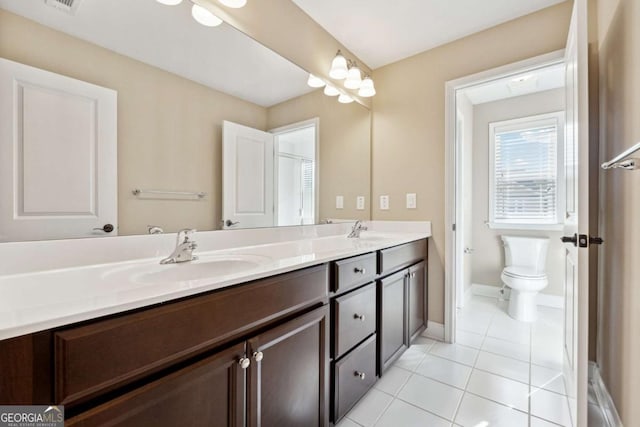 bathroom featuring toilet, tile patterned flooring, and vanity