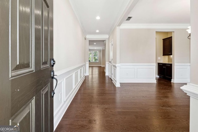 entrance foyer featuring dark hardwood / wood-style floors and crown molding