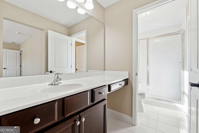 bathroom featuring a shower with shower door, vanity, tile patterned floors, and toilet