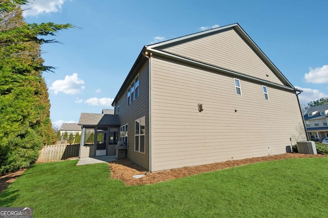 view of home's exterior with a patio area, central air condition unit, and a lawn