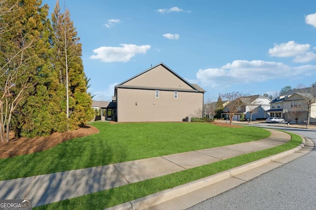 view of property exterior with a yard