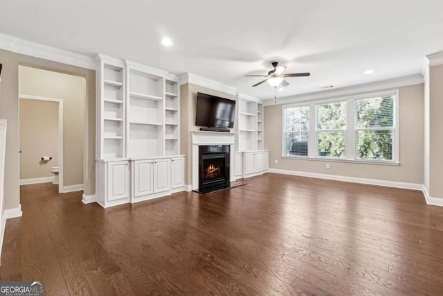 unfurnished living room with ceiling fan, dark wood-type flooring, built in features, and ornamental molding