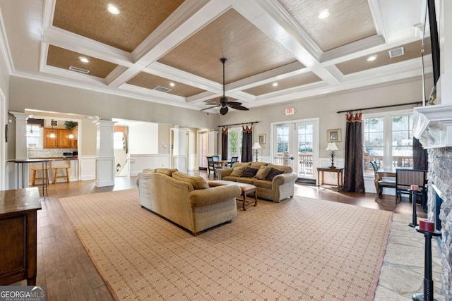 living room with beamed ceiling, crown molding, and coffered ceiling