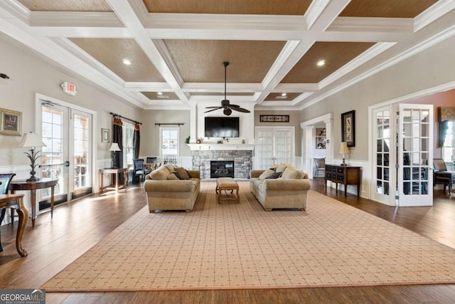 living room featuring ceiling fan, beam ceiling, crown molding, coffered ceiling, and french doors