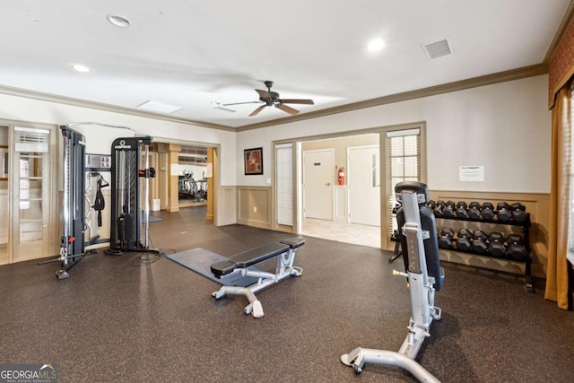 workout area with ceiling fan and crown molding