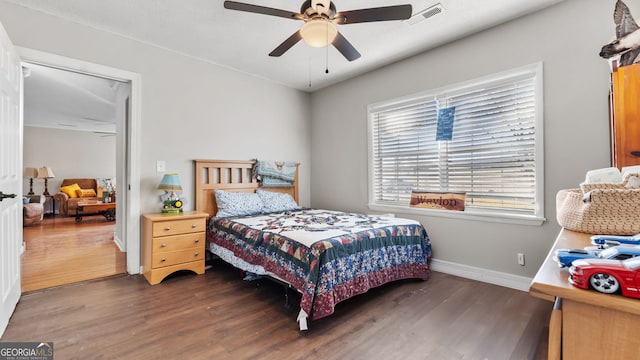 bedroom with ceiling fan and dark wood-type flooring