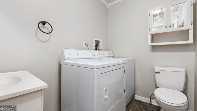 bathroom with toilet, vanity, independent washer and dryer, and ornamental molding