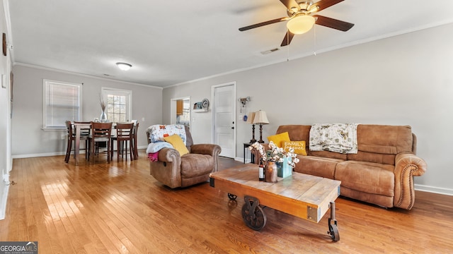 living room with ceiling fan, light hardwood / wood-style flooring, and ornamental molding