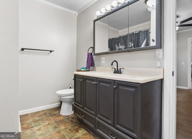 bathroom with ceiling fan, toilet, vanity, and crown molding