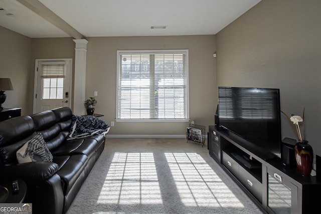 living room featuring light colored carpet and ornate columns