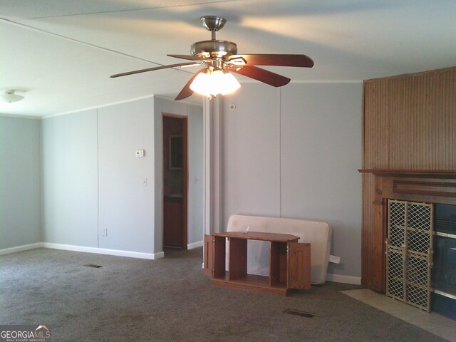 unfurnished living room featuring ornamental molding and carpet flooring