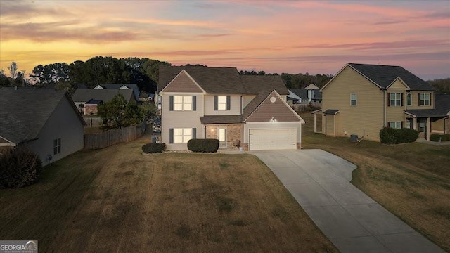 view of front of house with a garage and a lawn