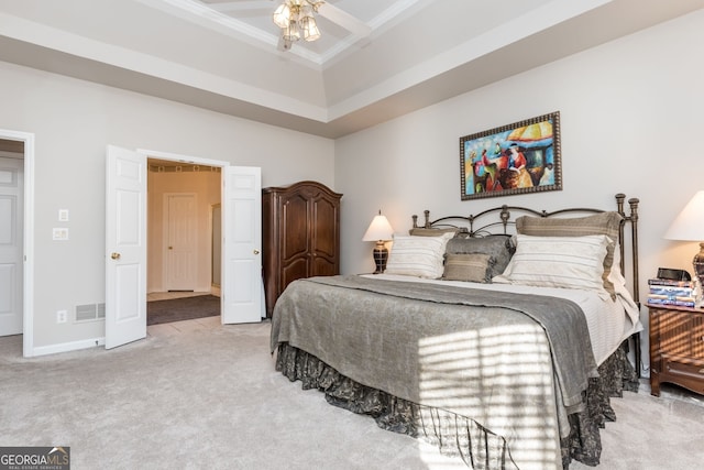 carpeted bedroom featuring a tray ceiling, crown molding, lofted ceiling, and ceiling fan