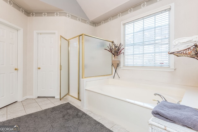 bathroom with vaulted ceiling, tile patterned floors, and separate shower and tub