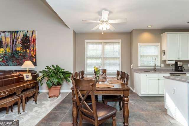 dining area featuring sink and ceiling fan