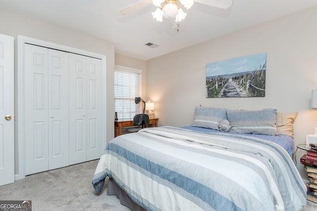 carpeted bedroom with a closet and ceiling fan