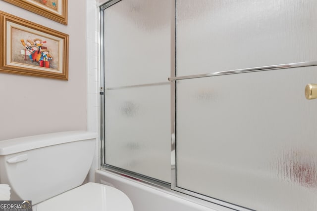 bathroom with enclosed tub / shower combo and toilet