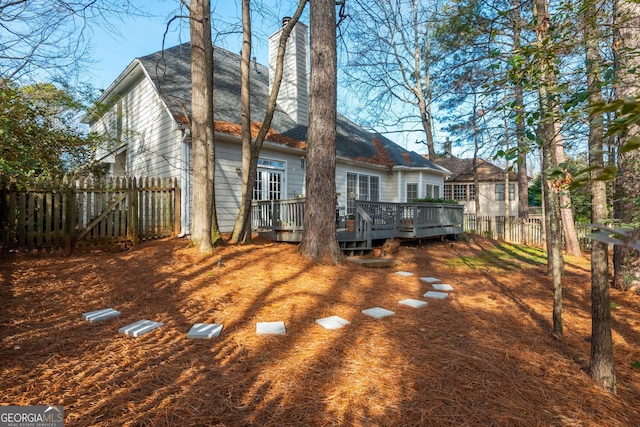 back of house featuring a wooden deck