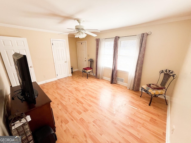 sitting room with ceiling fan, ornamental molding, and light hardwood / wood-style flooring