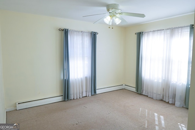 empty room with ceiling fan, a healthy amount of sunlight, and a baseboard radiator