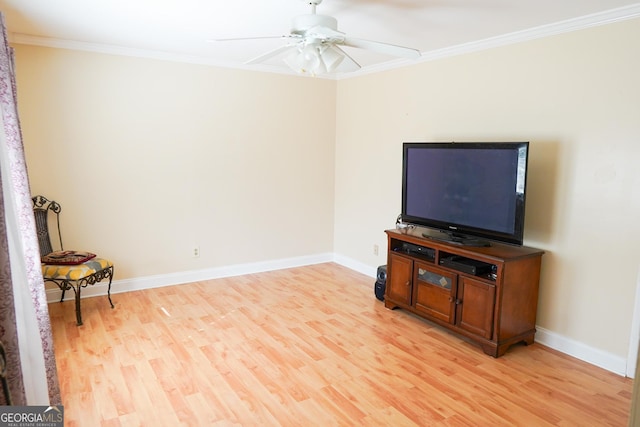 living room featuring ceiling fan, ornamental molding, and light wood-type flooring