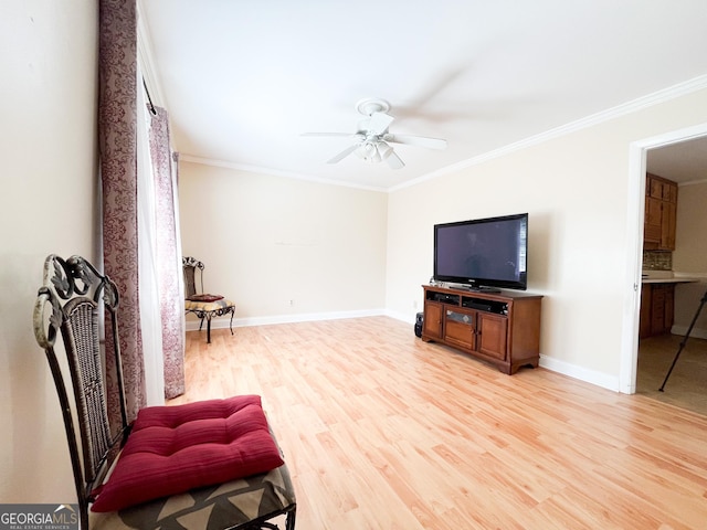 sitting room with ceiling fan, ornamental molding, and light hardwood / wood-style flooring