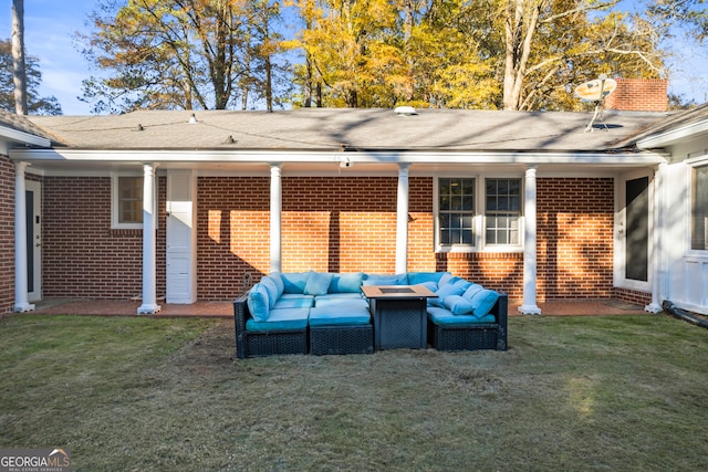 rear view of property with a yard, a chimney, an outdoor hangout area, and brick siding