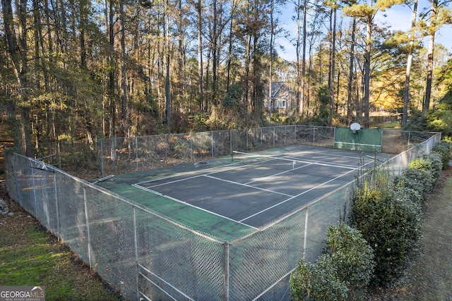 view of sport court featuring fence