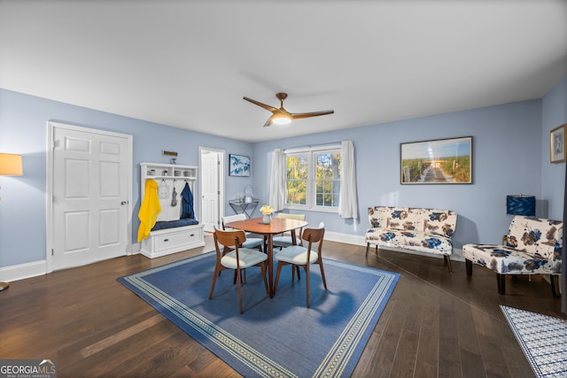 dining space featuring ceiling fan, dark wood finished floors, and baseboards