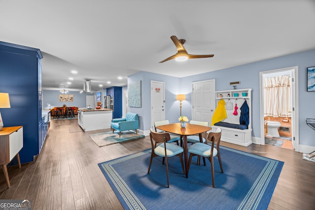 dining space featuring ceiling fan, baseboards, and dark wood-type flooring