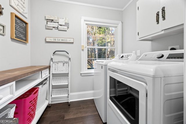 laundry room featuring dark wood-style flooring, cabinet space, ornamental molding, washer and dryer, and baseboards