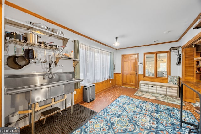 interior space with a wealth of natural light, wood walls, crown molding, and wainscoting