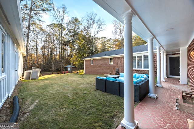 view of yard featuring a shed, an outdoor living space, and an outbuilding