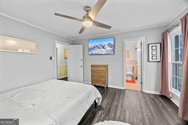 bedroom with crown molding, dark wood-type flooring, a ceiling fan, connected bathroom, and baseboards