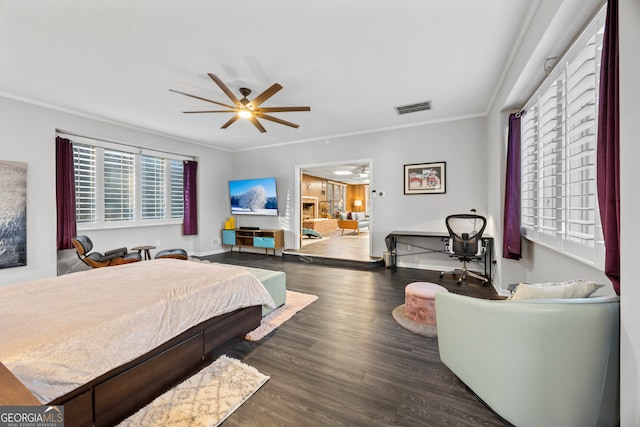 bedroom featuring baseboards, visible vents, dark wood-type flooring, and crown molding