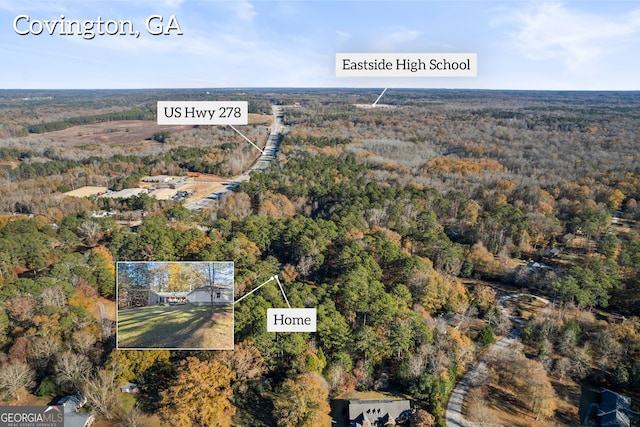 aerial view featuring a wooded view