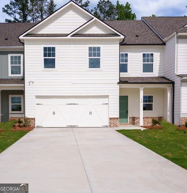28 Russet Way Lot 60, Newnan, GA 30263 - view of front facade with brick siding, a garage, concrete driveway, roof with shingles, and a front yard