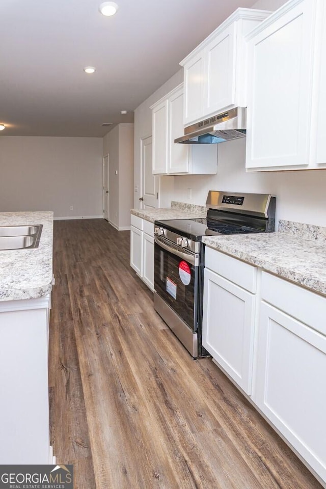 28 Russet Way Lot 60, Newnan, GA 30263 - kitchen with stainless steel electric range oven, under cabinet range hood, dark wood-style floors, white cabinetry, and recessed lighting