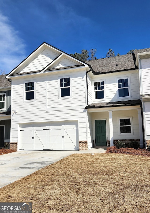 view of front facade featuring a garage, driveway, and brick siding